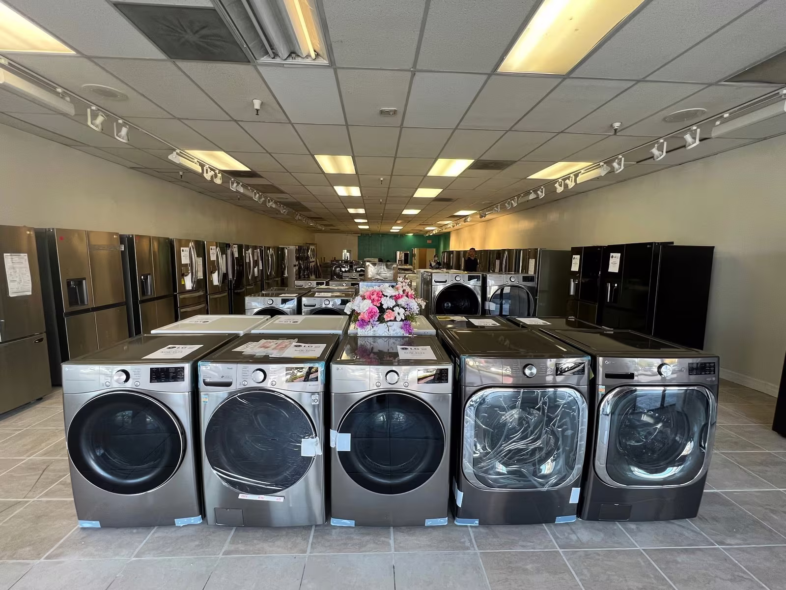 A row of front-load washers on the Corona showroom floor